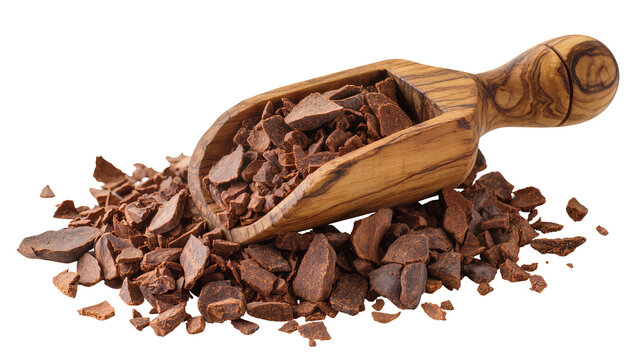 Wooden scoop filled with cacao nibs and scattered around