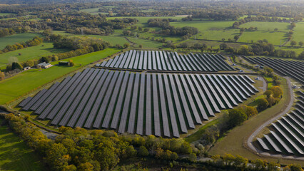 Fototapeta premium Solar farm generating renewable energy in rural landscape