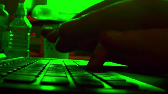 Timelapse.Cinematic macro of fast typing on a computer keyboard. Defocused background, low light. Visualizes overnight work, strict deadline, copywriting, content creation and productivity.