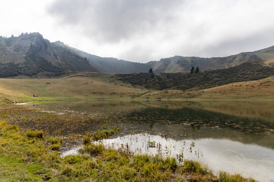 Mirror reflection on Lake Roy with cloudy sky in the Chablais massif, Haute-Savoie, French Alps