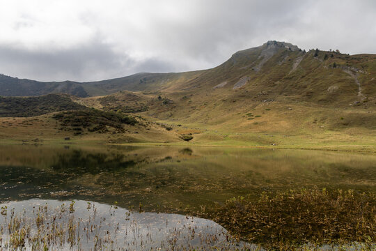 Mirror reflection on Lake Roy with cloudy sky in the Chablais massif, Haute-Savoie, French Alps