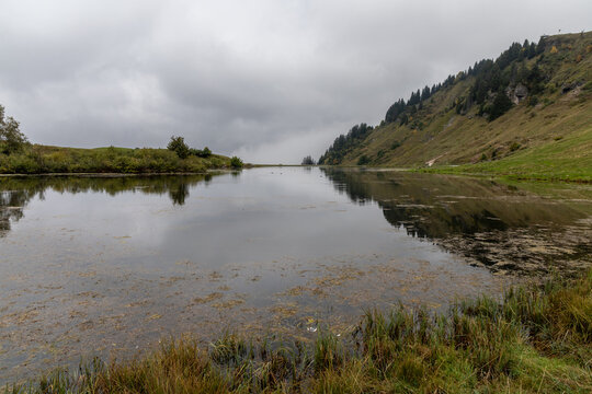 Lac de Joux Plane under a cloudy sky in the French Alps, Haute-Savoie