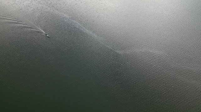 aerial view of boat crossing bay