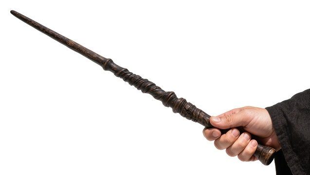 Hand holding a dark brown wooden magic wand with carved details