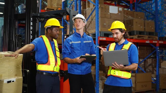 Worker discuss in warehouse using laptop in conversation. Safety inspection,Training employee for logistic employee in warehouse. Digital technology, Team meeting and supply chain with manager for hel
