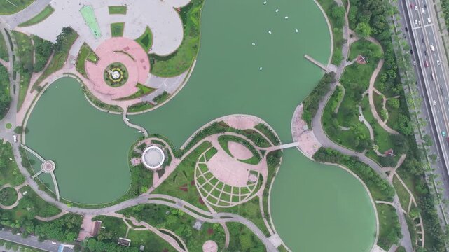 Top-down aerial view of Hoa Binh Park in Hanoi featuring ornamental lakes, landscaped pathways, and geometric garden design.