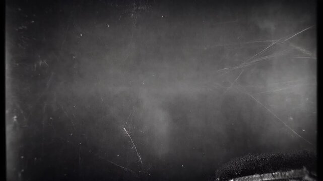Distressed vintage film texture with heavy scratches and dust particles for retro motion video effects