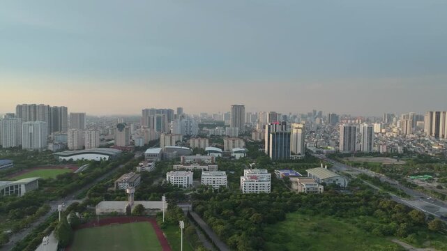 Aerial view of Tu Liem District in Hanoi with educational campuses, sports facilities, residential towers, and expanding urban development.