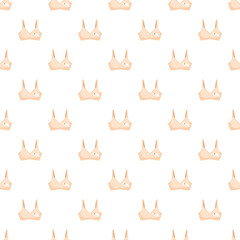 Fototapeta premium Seamless pattern of beige nursing bras for maternity and breastfeeding concepts