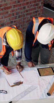 Construction, blueprint and men with site checklist for building regulations, inspection or above. Tablet screen, writing or workers with clipboard for project timeline, compliance notes and progress