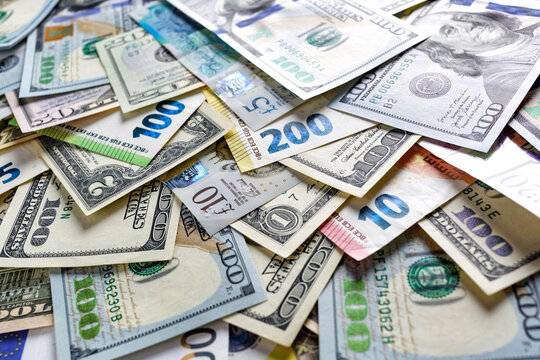 Closeup of assorted  banknotes.Money american hundred dollar bills.Currency of the USA, Britain and the European Union is scattered on the table. Currency, dollar, euro, pound, zloty.