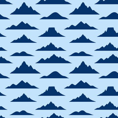 Obraz premium Seamless pattern of dark blue mountain silhouettes on a light blue background