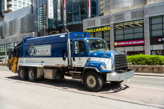Toronto Canada - May 26 2026 Waste Connections Garbage Truck Passing Downtown Retail Stores