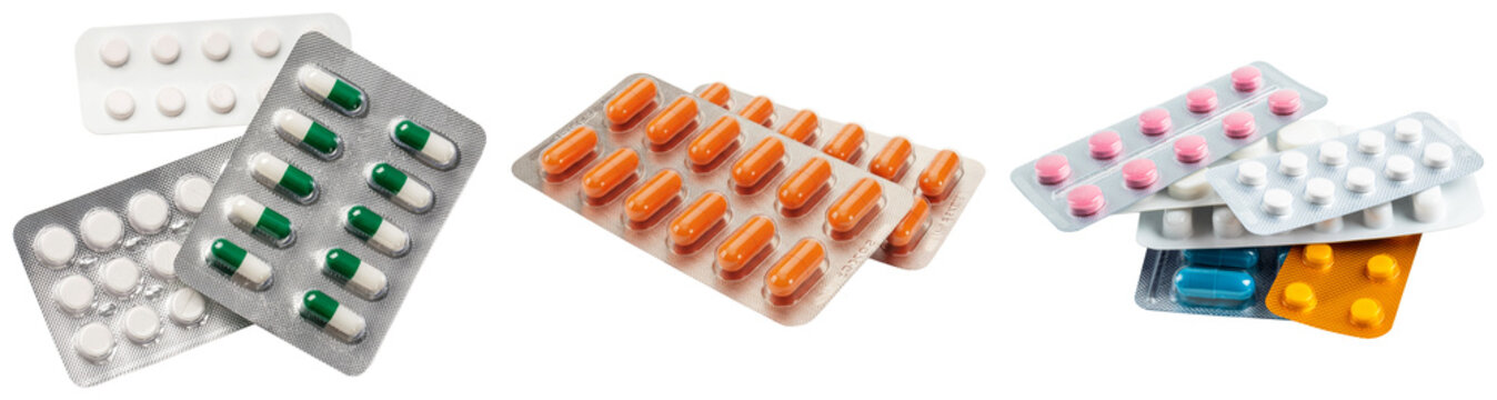 Various blister packs of pills and capsules isolated on a white background