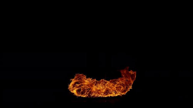 Super slow motion capture of a flickering fire flame isolated on a black background. High-speed footage reveals intricate combustion patterns, fluid motion, and glowing details.