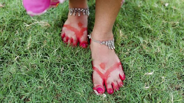 indian bridal foot decoration with red alta and traditional payal jewelry