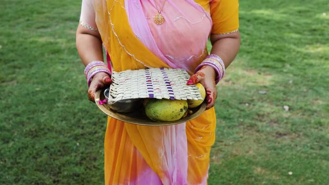women hand holding hindu puja plate in traditional attire religious ceremony concept