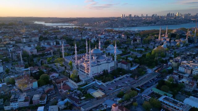 Istanbul cityscape with the iconic Sultan Ahmed Mosque and Hagia Sophia blending historical architecture with the modern Bosphorus skyline. speed ramp, time lapse fly reverse panorama drone