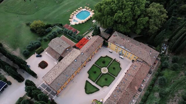 Walled courtyard with fountain and walkways. Formal garden area featuring fountain and surrounding roof structures