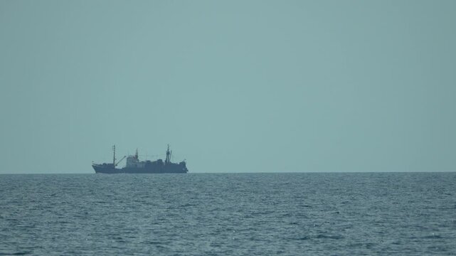 Ship ocean horizon, large vessel sailing peacefully across the calm sea under a clear serene sky