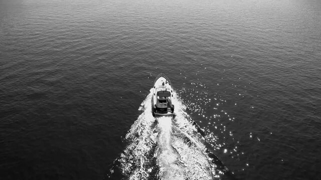 Quiet seaside landscape showcasing daring skipper navigating smooth waters