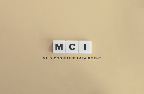 MCI Mild Cognitive Impairment Acronym on White Tiles Against Beige Background
