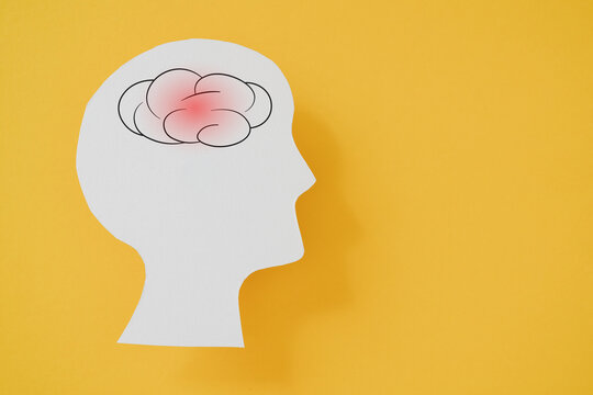 For BEFAST , balance, eye,  face, arm and speech  concept, brain inside real white paper cut of  man head on yellow background, including copy space