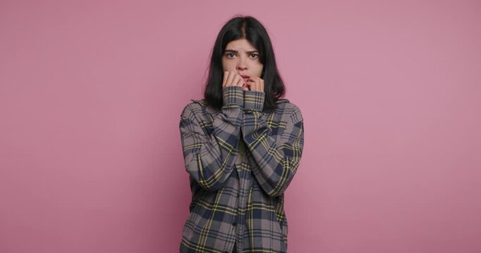 Feeling anxious while waiting in a quiet room with a pink background at a studio in the afternoon
