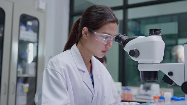 Scientific research in laboratory female scientist microscopy modern facility close-up view innovation and discovery
