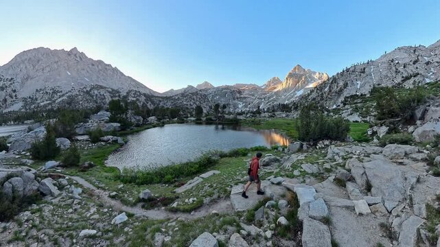 Man Hikes Around Switchback Past Alpine Lake in Kings Canyon National Park