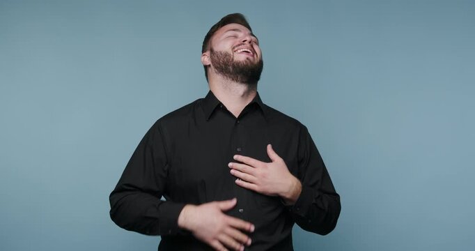Man shares joyful moments and laughter in a simple setting with light background during a daytime session