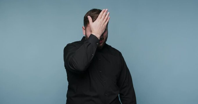 Man expresses frustration in a series of gestures in a simple blue background setting