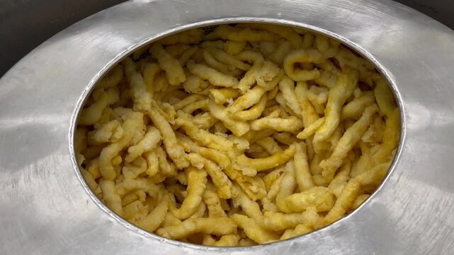 Fish maw undergoing dewatering and oil removal during food manufacturing operations. Ingredient preparation process used to improve product consistency and support large-scale food production.