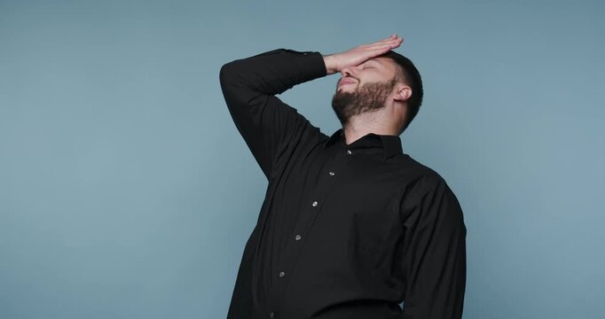 Man expresses different emotions in front of blue background during short performance