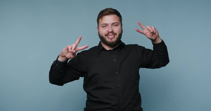 Man shows fun hand gestures in four different poses in a studio setting