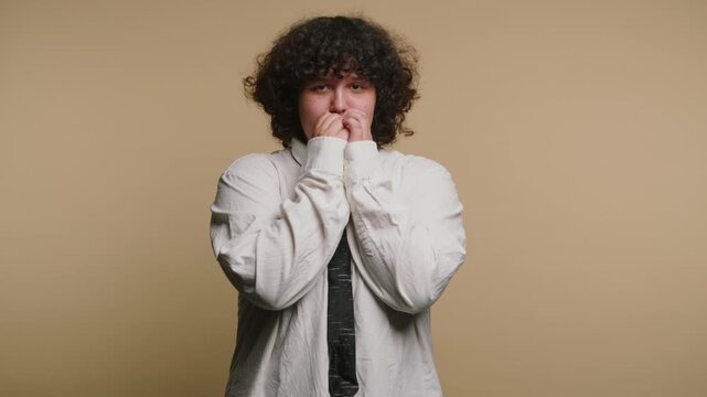 Person shows different emotions through expressions and body language in a simple studio setting with a plain background