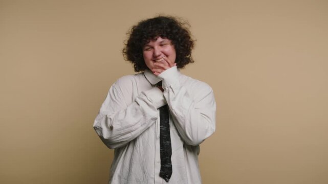 Smiling person shares happy moments in simple studio setting with beige background