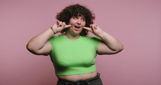 Smiling person shows different expressions in a colorful background in a studio at day