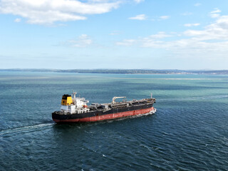Fototapeta premium Aerial high angle view of an industrial oil tanker ship sailing in the open sea