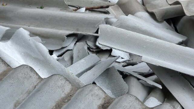 Pile of broken asbestos cement roofing sheets, close up
