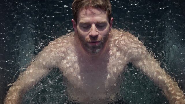 Cold recovery defines the moment as a man submerges in an outdoor ice bath