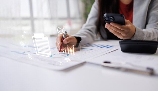 Business professional analyzing digital data, reviewing financial reports, and using a mobile phone, incorporating technology for strategic planning and smart investment management