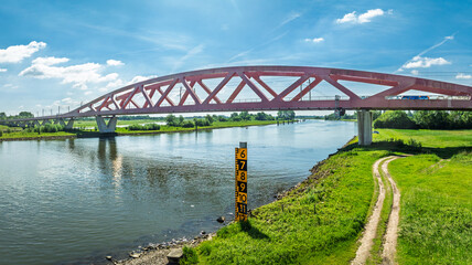 Fototapeta premium Aerial view of the Hanzeboog (Hanseatic Arch), a combined railway and cycle bridge spanning the IJssel river. The bridge was opened in June 2011