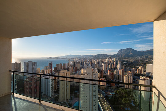 Benidorm Spain balcony view opens over Mediterranean sea, skyline and apartment towers from a high terrace beneath warm coastal light
