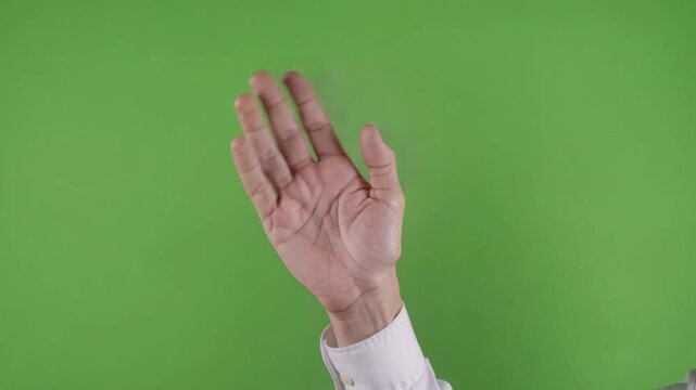 Businessman's hand gesturing a friendly wave to say hello or goodbye. Close up footage on a chroma key background for easy replacement