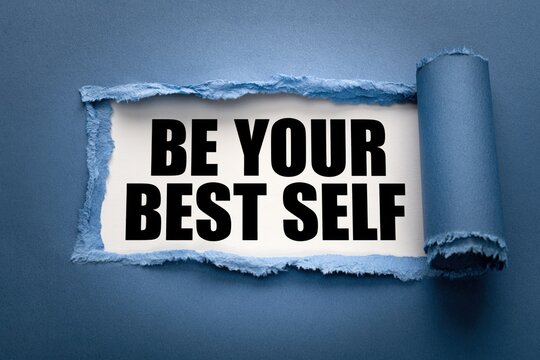 Be your best self concept shown behind torn blue paper