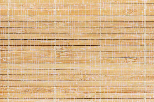 Natural bamboo mat texture background with white woven net overlay and horizontal rustic timber splints for creative mockup design