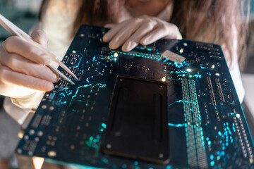 Obraz premium A technician uses tweezers to handle small components on a circuit board in a lab setting during the day