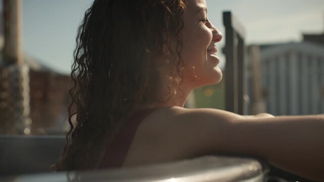 Relaxation surrounds the woman in a warm outdoor hot tub at a spa retreat
