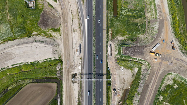 Aerial drone view of a new viaduct over the A27, showing bridge demolition, road widening, infrastructure expansion and improved access to bedrijventerrein Groote Haar.